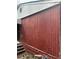 Exterior image with weathered red siding, gray trim, and cement steps at 2625 Baker Nw Rd, Atlanta, GA 30318