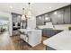 Stylish kitchen boasts an island with seating, gray cabinets, and modern appliances, perfect for cooking and gathering at 5350 Hyde Rd, Cumming, GA 30040