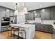 Modern kitchen features gray cabinets, a center island with seating, and stainless steel appliances at 5350 Hyde Rd, Cumming, GA 30040