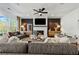 Spacious living room with fireplace, ceiling fan, recessed lighting, and comfortable seating, perfect for relaxation and entertainment at 5350 Hyde Rd, Cumming, GA 30040