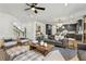 Open-concept living room seamlessly connects to the kitchen, offering a spacious layout with modern furnishings and decor at 5350 Hyde Rd, Cumming, GA 30040