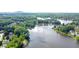 Breathtaking aerial view of a tranquil lake surrounded by lush greenery and beautiful homes at 7435 Woodruff Way, Stone Mountain, GA 30087