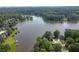 Scenic aerial view of a lakefront community surrounded by lush green trees and beautiful waterfront homes at 7435 Woodruff Way, Stone Mountain, GA 30087