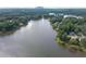 Gorgeous aerial view of a tranquil lake surrounded by lush forests and beautiful homes at 7435 Woodruff Way, Stone Mountain, GA 30087