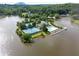 Panoramic aerial view of a vibrant lakeside community featuring a resort-style pool and multiple tennis courts at 7435 Woodruff Way, Stone Mountain, GA 30087