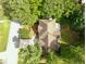 Aerial view of a house with a large backyard and a deck with patio furniture surrounded by lush greenery at 7435 Woodruff Way, Stone Mountain, GA 30087