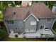 Aerial view of the home's back exterior, showcasing a spacious deck, patio area, and serene backyard at 7435 Woodruff Way, Stone Mountain, GA 30087
