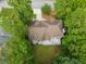 Aerial view of a house with a large backyard, a deck with patio furniture, and lush green trees at 7435 Woodruff Way, Stone Mountain, GA 30087