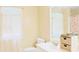 Bright bathroom with double sink vanity, floral shower curtain, and sheer curtains over a window at 7435 Woodruff Way, Stone Mountain, GA 30087
