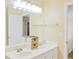 Bright bathroom featuring a double sink vanity with a large mirror, and a nearby doorway at 7435 Woodruff Way, Stone Mountain, GA 30087