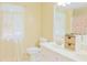 Bright bathroom with double sink vanity, floral shower curtain, and sheer curtains over a window at 7435 Woodruff Way, Stone Mountain, GA 30087