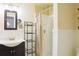 Traditional bathroom with a modern vanity, well-lit mirror, and a bathtub with a shower curtain at 7435 Woodruff Way, Stone Mountain, GA 30087