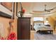 This primary bedroom features a tray ceiling, ceiling fan, and neutral walls with hardwood floors at 7435 Woodruff Way, Stone Mountain, GA 30087