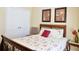 Cozy bedroom featuring a comfortable bed with floral patterned sheets and a closet with traditional double doors at 7435 Woodruff Way, Stone Mountain, GA 30087