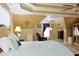Spacious bedroom with a light blue bedspread, tray ceiling, and a cozy reading area at 7435 Woodruff Way, Stone Mountain, GA 30087