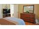 Bedroom with natural light, wood floors, and a view into the bathroom at 7435 Woodruff Way, Stone Mountain, GA 30087