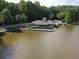 Waterfront clubhouse features a private pier, providing a serene setting for social gatherings and lakeside enjoyment at 7435 Woodruff Way, Stone Mountain, GA 30087