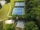 Aerial shot of tennis and basketball courts near the lake, offering residents diverse recreational options at 7435 Woodruff Way, Stone Mountain, GA 30087