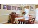 Lovely dining area with a wooden table set and Gathering pictures displayed on the walls at 7435 Woodruff Way, Stone Mountain, GA 30087