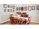 Charming dining room with a wooden table, chandelier, and beautiful Gathering picture displays at 7435 Woodruff Way, Stone Mountain, GA 30087