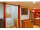 Cozy kitchen area with stainless steel refrigerator, ample cabinet space, and bright orange walls at 7435 Woodruff Way, Stone Mountain, GA 30087