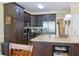Bright kitchen featuring a granite island, stainless steel appliances, and dark cabinetry at 7435 Woodruff Way, Stone Mountain, GA 30087