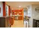 A modern kitchenette with stainless steel appliances, wooden cabinets and a breakfast bar at 7435 Woodruff Way, Stone Mountain, GA 30087