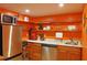 A modern kitchenette with stainless steel appliances, solid countertops, and open shelving at 7435 Woodruff Way, Stone Mountain, GA 30087
