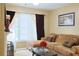Cozy living room with fireplace, comfortable seating, and natural light at 7435 Woodruff Way, Stone Mountain, GA 30087