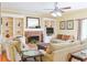 Cozy living room featuring a brick fireplace, built-in shelving, and comfortable seating at 7435 Woodruff Way, Stone Mountain, GA 30087