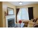 Cozy living room with fireplace, comfortable seating, and natural light at 7435 Woodruff Way, Stone Mountain, GA 30087