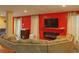 Comfortable living room featuring a fireplace, media center, and a large, curved sofa for ample seating at 7435 Woodruff Way, Stone Mountain, GA 30087