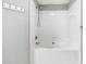 Close-up of a white tub and shower featuring tile and chrome hardware at 805 Abbotts Mill Ct # 74, Duluth, GA 30097