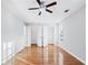 Bright bedroom with hardwood floors, ceiling fan, and double-door closets at 805 Abbotts Mill Ct # 74, Duluth, GA 30097