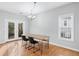 Dining room with wood table, hardwood floors, and French doors to a deck at 805 Abbotts Mill Ct # 74, Duluth, GA 30097