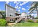 Wide backyard showcasing a well-maintained lawn, multi-level deck, and blue sky at 1104 Victoria Ne St, Brookhaven, GA 30319