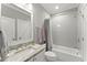 Contemporary bathroom featuring sleek fixtures, granite counters, and tiled shower at 1104 Victoria Ne St, Brookhaven, GA 30319