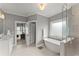 Serene bathroom featuring a soaking tub, a glass-enclosed shower, double vanities, and ample natural light at 1104 Victoria Ne St, Brookhaven, GA 30319