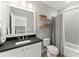 Clean bathroom with vanity, shower with grey curtain, and stylish mirror and shelves at 1104 Victoria Ne St, Brookhaven, GA 30319