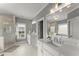 Bright bathroom with double vanity, quartz countertops, and glass shower, offering a modern and refreshing space for daily routines at 1104 Victoria Ne St, Brookhaven, GA 30319