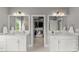 Bathroom with double vanities, mirrors, and lighting fixtures; walk-in closet is located straight ahead at 1104 Victoria Ne St, Brookhaven, GA 30319