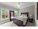 Bedroom featuring a large bed, full-length mirror, and neutral color palette at 1104 Victoria Ne St, Brookhaven, GA 30319