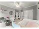 Bright bedroom with a ceiling fan, grey accent chair, and carpet flooring at 1104 Victoria Ne St, Brookhaven, GA 30319