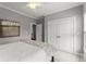 Neutral bedroom with closet and dark accent wall; ceiling fan and white trim at 1104 Victoria Ne St, Brookhaven, GA 30319