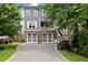 Charming two-story home featuring gray siding, brick accents, and a spacious two-car garage at 1104 Victoria Ne St, Brookhaven, GA 30319