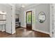 Elegant foyer with hardwood floors, stylish lighting, and convenient access to a half bathroom at 1104 Victoria Ne St, Brookhaven, GA 30319