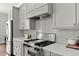 Well-equipped kitchen featuring stainless steel appliances and stylish gray cabinetry at 1104 Victoria Ne St, Brookhaven, GA 30319