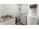 Bright laundry room with granite countertops, sink, washer, and dryer, offering convenience and functionality at 1104 Victoria Ne St, Brookhaven, GA 30319