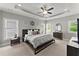 Spacious main bedroom with tray ceiling, ceiling fan, multiple windows, and neutral color palette at 1104 Victoria Ne St, Brookhaven, GA 30319