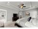 Relaxing main bedroom featuring tray ceiling, ceiling fan, neutral colors, and a glimpse of an adjoining bathroom at 1104 Victoria Ne St, Brookhaven, GA 30319
